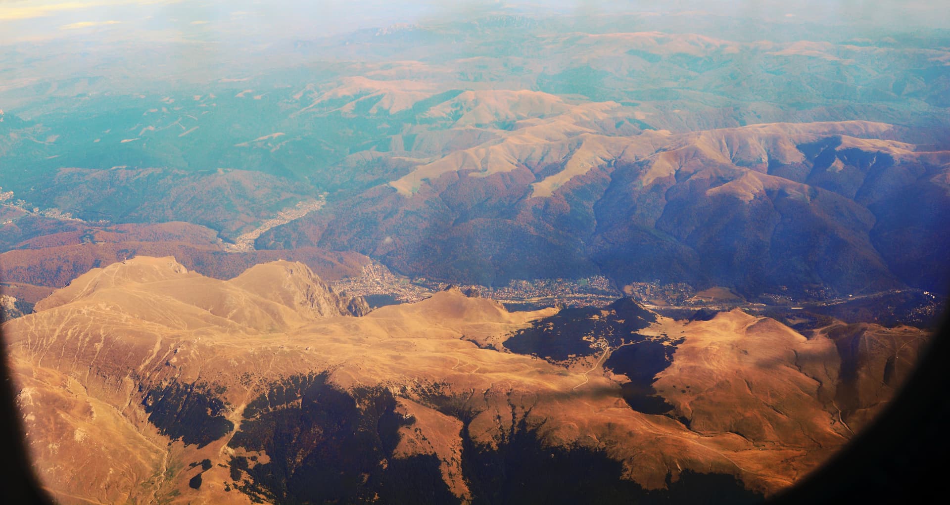Aerial photograph looking east toward Azuga and Bușteni, Prahova County, Romania.jpg